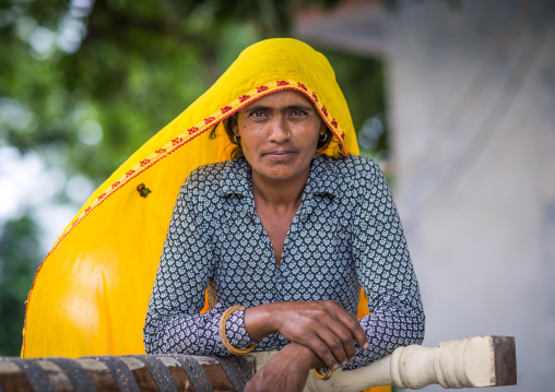 Portrait of a rajasthani woman in traditional yellow sari, Rajasthan, Baswa, India