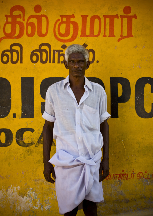 Indian Man With Gray Hairs And A White Shirt Posing In Front Of A Yellow Wall, Periyar, India
