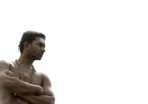 Priest With Traditional Painting On His Forehead Standing Idly During Hindu Ceremony In Pondicherry, India