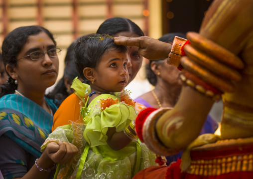 Little Girl With Sandalwood Paste On Her Hairs In  The Arms Of Her Mother Received Blessing From The Theyyam, Thalassery, India