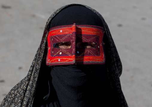 a bandari woman wearing the traditional mask called the burqa on a market, Hormozgan, Bandar Abbas, Iran