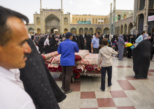 Men putting carpets for praying in the shrine of fatima al-masumeh, Qom province, Qom, Iran