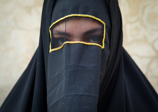 Portrait of an iranian shiite muslim woman with her face hidden by a veil mourning Imam Hussein on Tasua during the Chehel Manbar ceremony one day before Ashura, Lorestan Province, Khorramaba