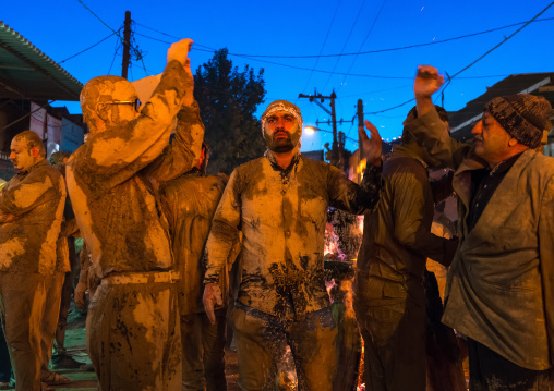 Iranian shiite muslim men gather around a bonfire after rubbing mud on their bodies during the Kharrah Mali ritual to mark the Ashura ceremony, Lorestan Province, Khorramabad, Iran