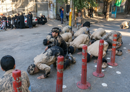 Iranian shiite muslim men praying in the street during the Ashura day, Lorestan Province, Khorramabad, Iran