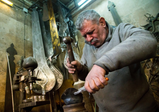 master safar fooladgar creating an alam in his workshop, Central district, Tehran, Iran