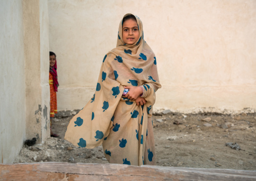 portrait of young girl wearing a chador with apple logos, Qeshm Island, Laft, Iran