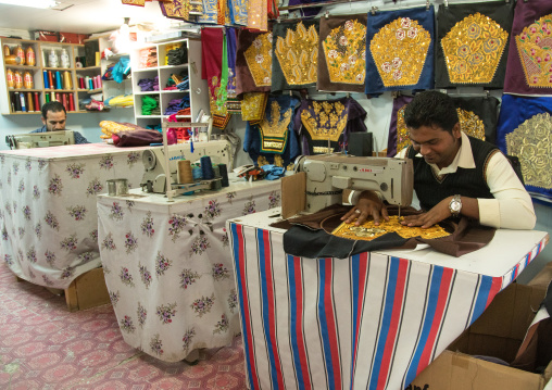 tailor using a sewing machine to make embroideries, Qeshm Island, Salakh, Iran