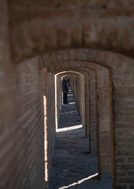 man walking under bridge arches, Isfahan Province, isfahan, Iran