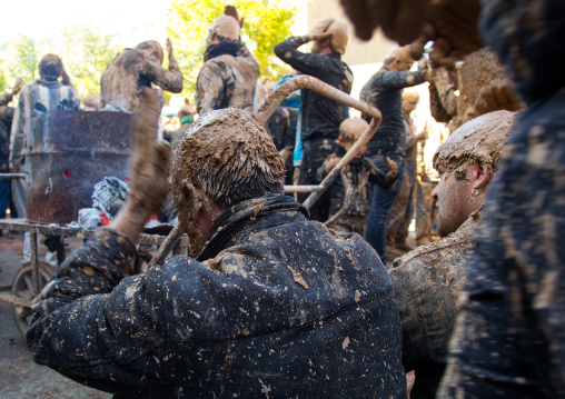 Iranian Shiite Muslim Men Covered In Mud Searching For Heat In Front Of A Fire During Ashura Day, Kurdistan Province, Bijar, Iran