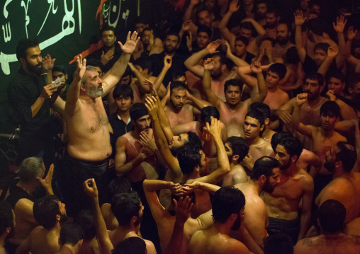 Iranian Shiite Muslim Man Leading Recitations And Songs With The Mad Of Hussein Mourners During Muharram, Isfahan Province, Kashan, Iran