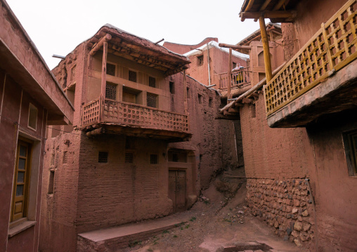 Iranian Woman Standing At The Balcony Of An Ancient Building In Zoroastrian Village, Isfahan Province, Abyaneh, Iran