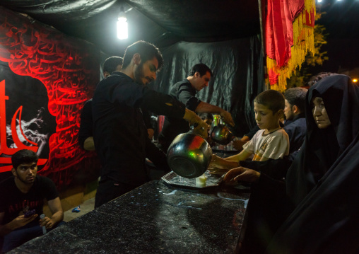 Iranian Shiite Muslim People Serving Nazri Hot Milk Distributed Freely To Mourners During Muharram, Isfahan Province, Kashan, Iran