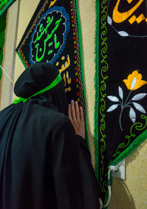 Iranian Woman Kissing A Shiite Banner For Chehel Menbari Festival On Tasu'a Day To Commemorate The Anniversary Of Imam Hussein, Lorestan Province, Khorramabad, Iran