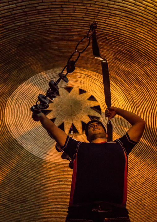 Iranian Man Training With Kabbadeh Chain And Bow At Saheb A Zaman Club Zurkhaneh, Yazd Province, Yazd, Iran