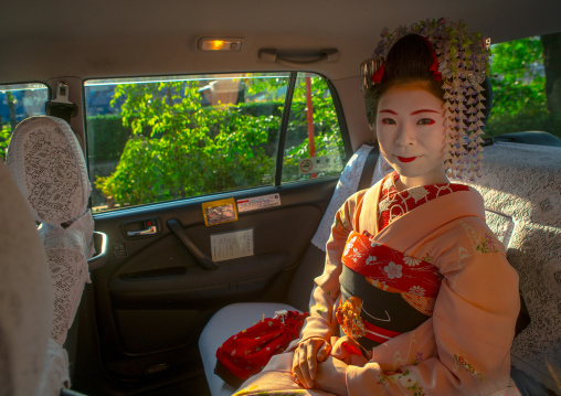 16 Years old maiko called chikasaya in a taxi, Kansai region, Kyoto, Japan