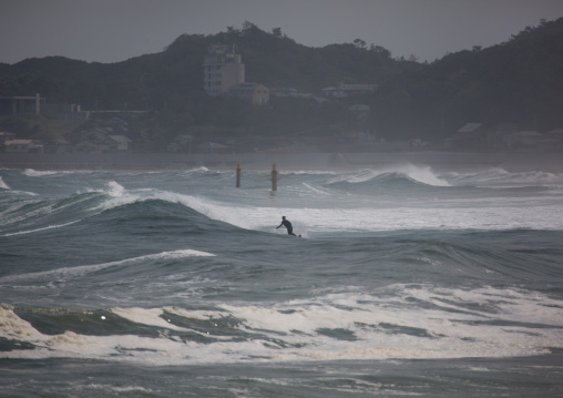 Japanese surfer in the contaminated area after the daiichi nuclear power plant irradiation, Fukushima prefecture, Tairatoyoma beach, Japan