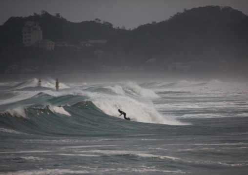 Japanese surfer in the contaminated area after the daiichi nuclear power plant irradiation, Fukushima prefecture, Tairatoyoma beach, Japan