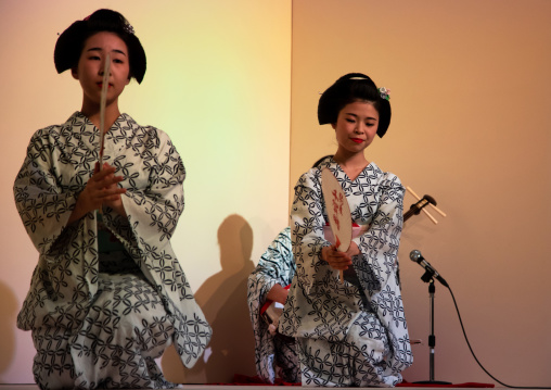 Maiko women dancing on stage during a show, Kansai region, Kyoto, Japan