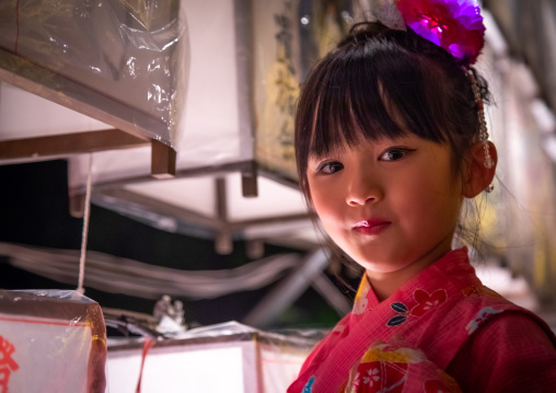 Japanese girl in yaukuta during Gokoku shrine Mitama matsuri Obon festival celebrating the return of the spirits of the deads, Kyushu region, Fukuoka, Japan