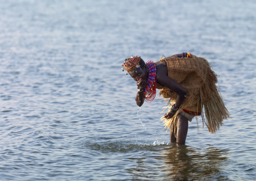 El Molo tribe woman drinking in the lake, Rift Valley Province, Turkana lake, Kenya
