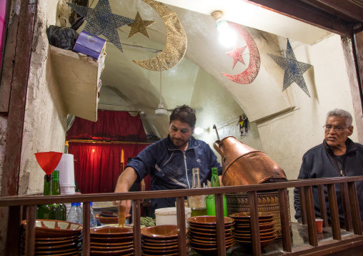 Man cooking beans to make foul for breakfast in a restaurant, South Governorate, Tyre, Lebanon