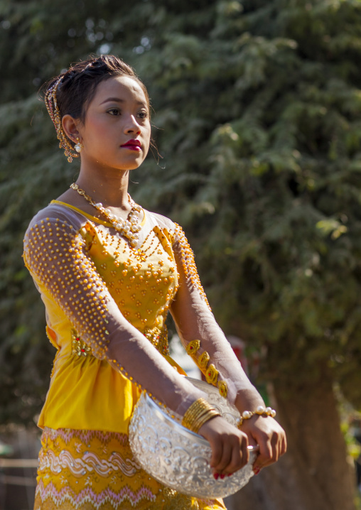 Woman Walking To The Temple With Offerings For A Novitiation Ceremony, Bagan,  Myanmar