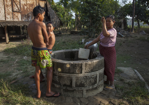 Rohingya Children With Their Mother In Front Of The Village Well, Thandwe, Myanmar