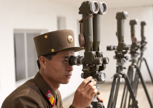 North Korean soldier looking south Korea with binoculars at the Demilitarized Zone, North Hwanghae Province, Panmunjom, North Korea