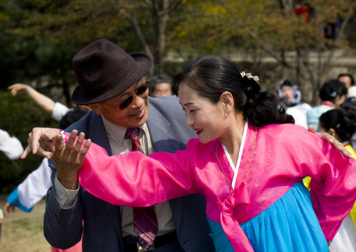 North Korean people dancing in a park for the day of the sun which is the birth anniversary of Kim Il-sung, Pyongan Province, Pyongyang, North Korea