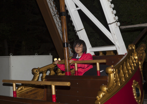 North Korean woman in a fairground attraction at Kaeson youth park, Pyongan Province, Pyongyang, North Korea