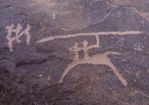 Petroglyphs on a rock depicting hunters, Najran Province, Thar, Saudi Arabia