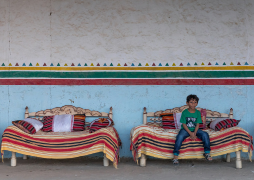 Saudi child sit inside a majlis, Jizan Province, Jizan, Saudi Arabia