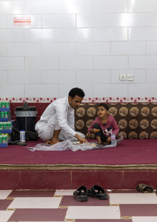 Saudi father and son eating in a local restaurant, Jizan Province, Sabya, Saudi Arabia
