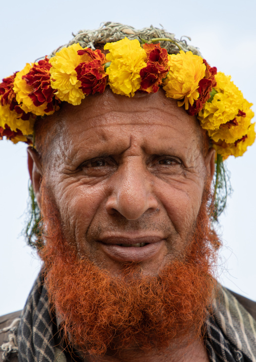 Portrait of a flower man with a red beard wearing a floral crown on the head, Jizan Province, Addayer, Saudi Arabia