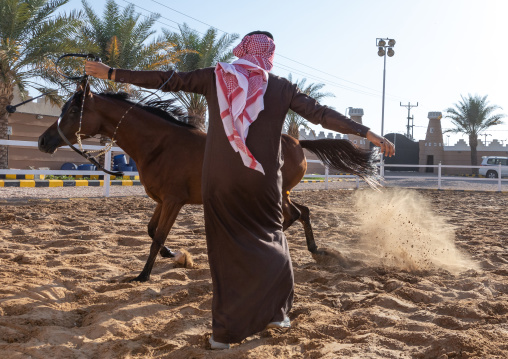 saudi man with his Arabian horse in Alhazm stud, Najran Province, Khubash, Saudi Arabia