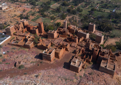 Aerial view of red stone and mud houses with slates in a village, Asir province, Sarat Abidah, Saudi Arabia