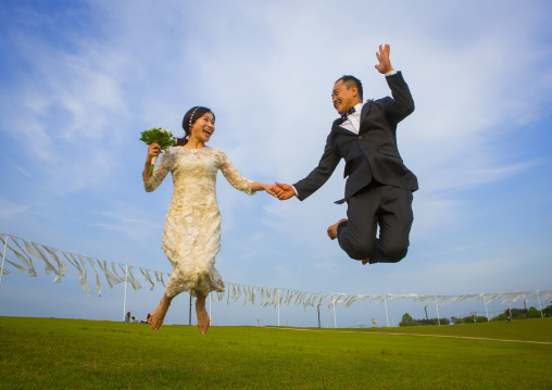 North korean defector joseph park with his south korean fiancee called juyeon jumping in imjingak park, Sudogwon, Paju, South korea