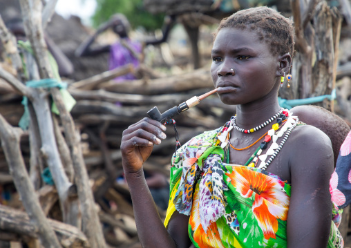 Toposa tribe woman smoking pipe in a village, Namorunyang State, Kapoeta, South Sudan