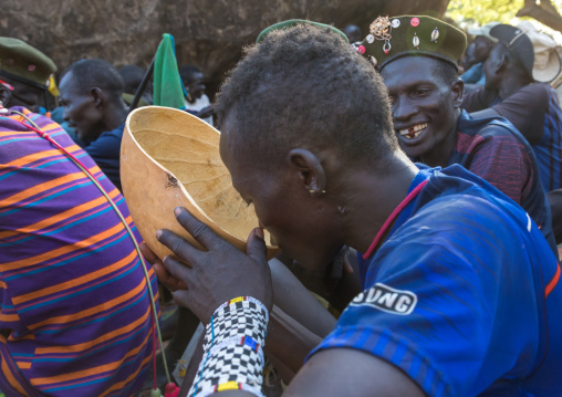 Miundari man drinking alcohol during a wedding ceremony, Boya Mountains, Imatong, South Sudan