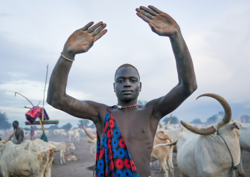 A Mundari tribe man mimics the position of horns of his favourite cow, Central Equatoria, Terekeka, South Sudan