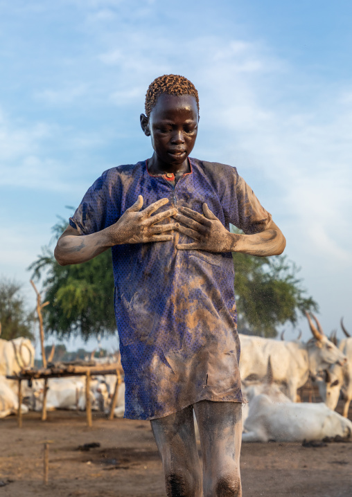 Mundari tribe man putting ash on his body after showering with cow urine, Central Equatoria, Terekeka, South Sudan