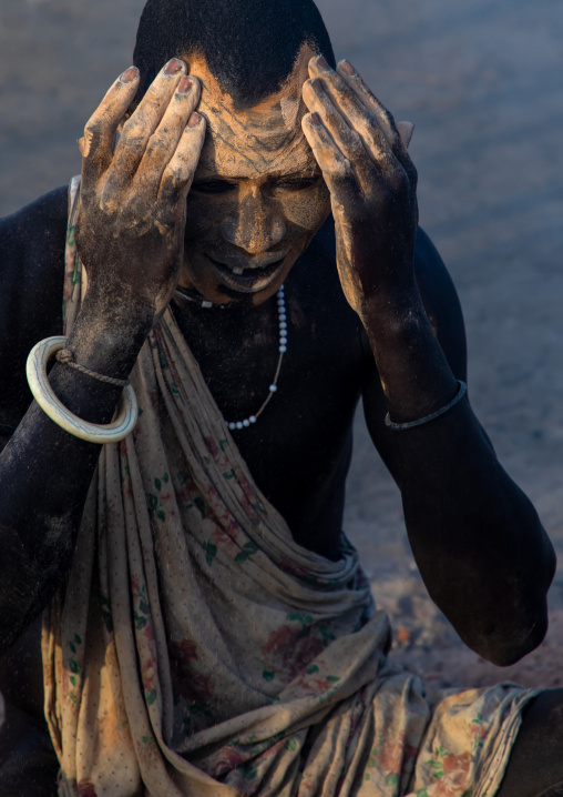 Mundari tribe man covering his body in ash to repel flies and mosquitoes, Central Equatoria, Terekeka, South Sudan