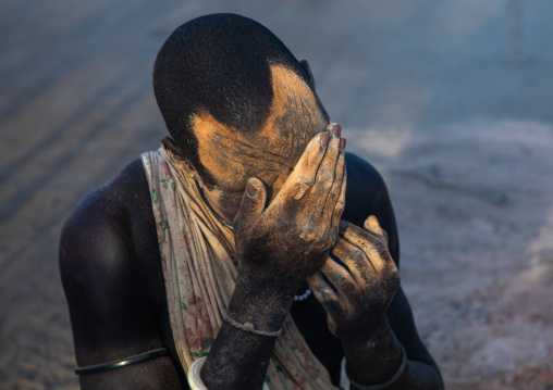 Mundari tribe man covering his body in ash to repel flies and mosquitoes, Central Equatoria, Terekeka, South Sudan